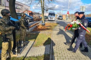 Za-ca komendanta Wojewódzkiego Policji i dowódca SPAP składają kwiaty pod pomnikiem zamordowanego policjanta